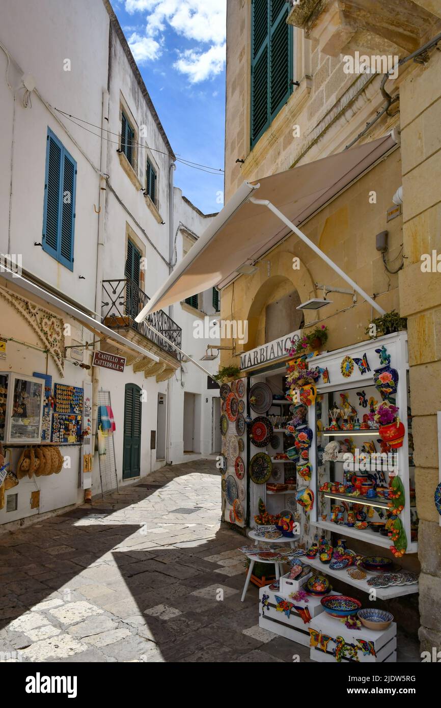 A narrow street among the old houses in the historic center of Otranto, a town in Puglia in