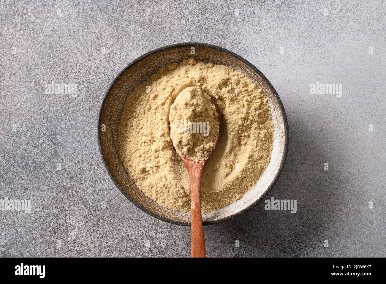 Sesame flour in bowl for cooking vegan gluten-free dessert. Stock Photo