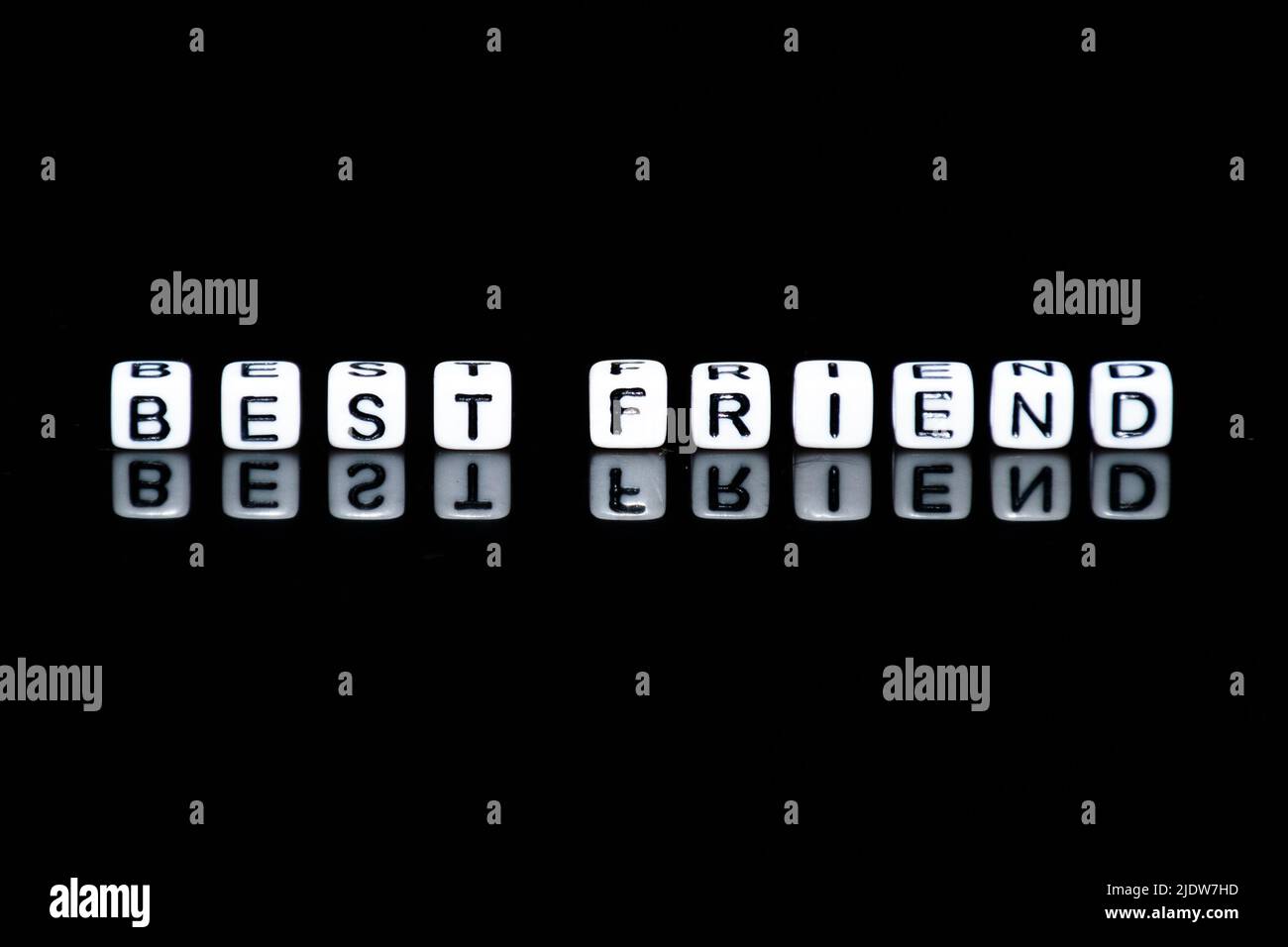 The word of 'BEST FRIEND' making from little acrylic cubes in black background. Stock Photo