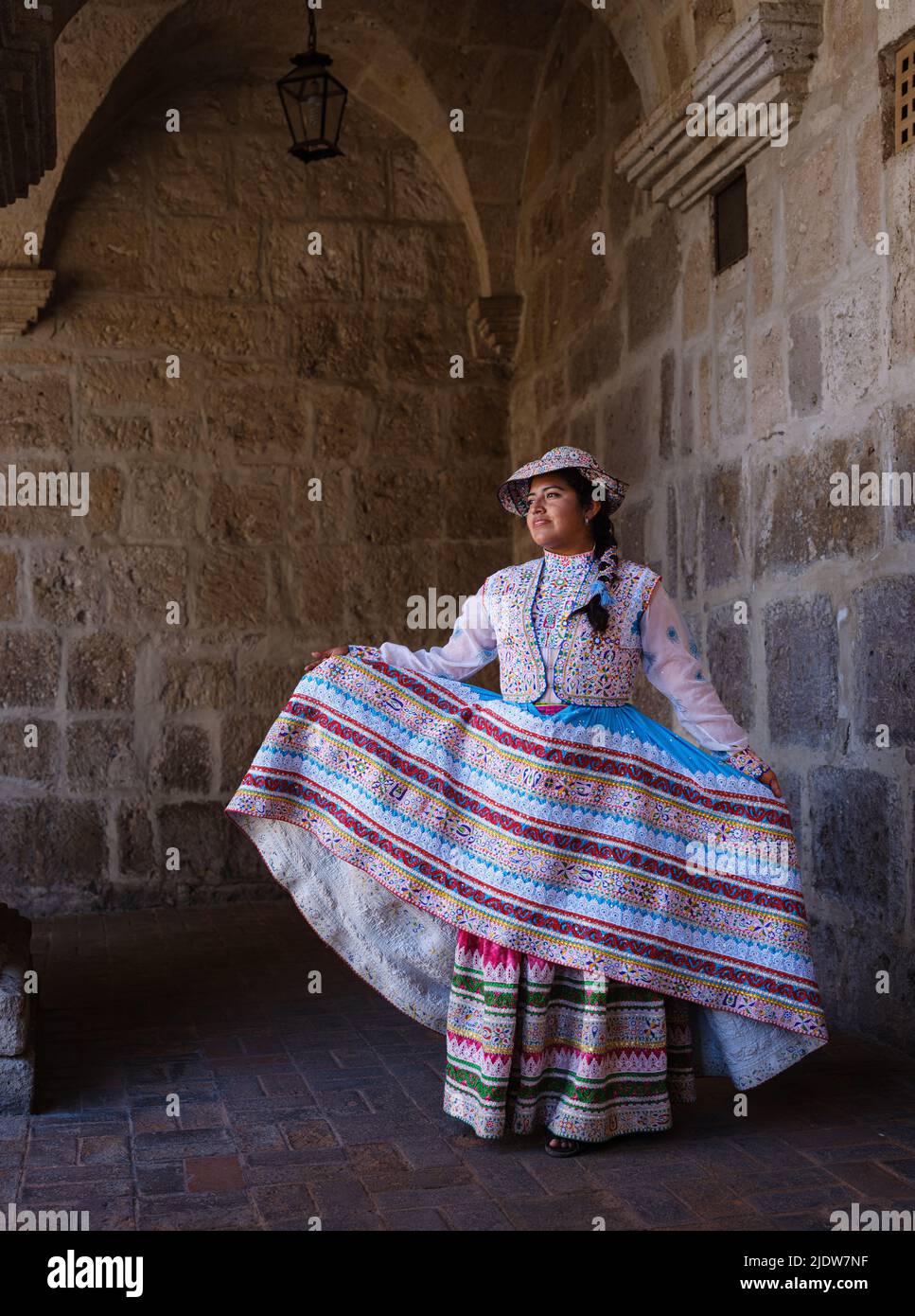 AREQUIPA, PERU - CIRCA SEPTEMBER 2019: Young Peruvian woman smiling and wearing a typical andean dress. Stock Photo