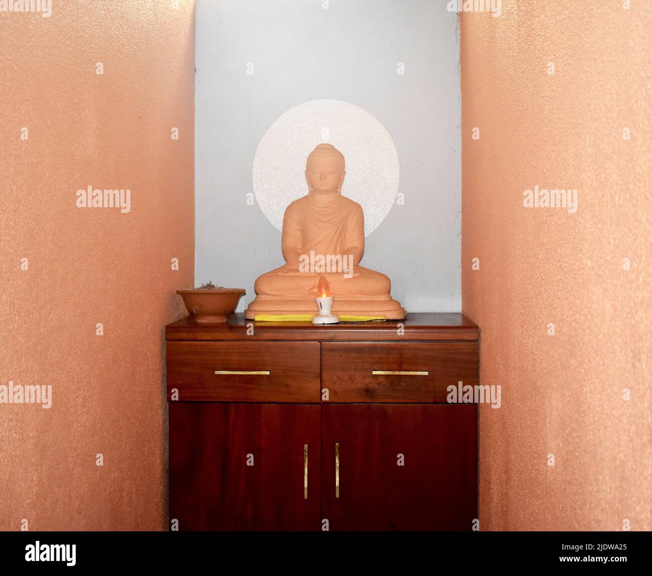 A Buddhist statue at a an Ayurveda therapy center. A remarkably simple practice and a form of healing, Ayurveda promotes a perfect harmony between mind and body. Sri Lanka's indigenous medicine has similar origins, linked to the 30,000 year old native habitants of the land known as the Balangoda man (manavaya). With its ancient history, traditional ayurveda medicine as it is practiced today in the country, is based on an indigenous heritage preserved over 3000 years. Sri Lanka. Stock Photo