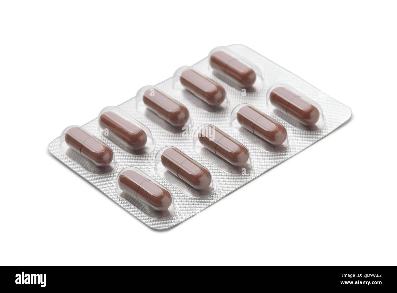 Brown capsules in aluminum blister pack isolated on white Stock Photo