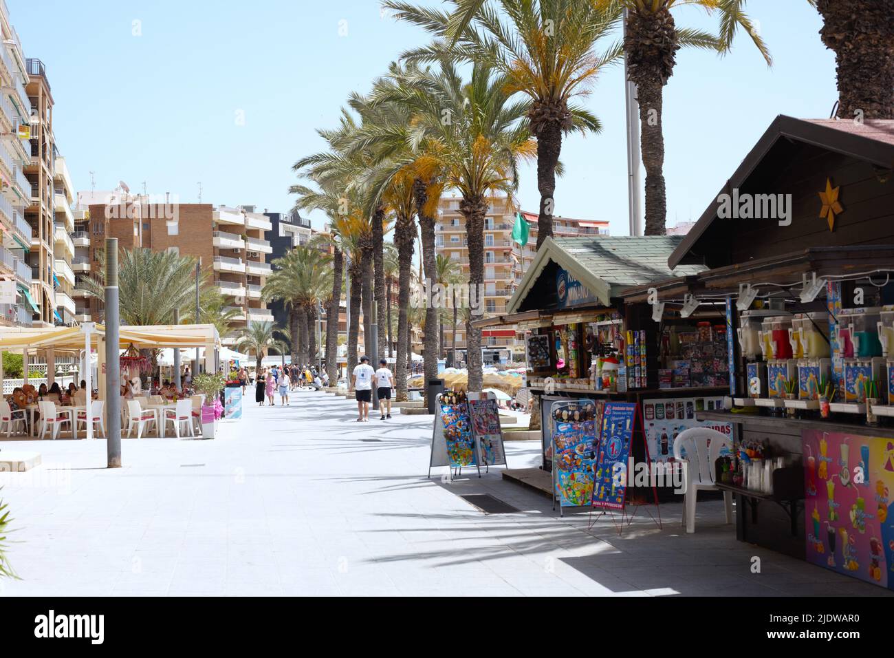 Seaside city -  view of pedestrians walking along beach promenade at Torrevieja Spain Stock Photo