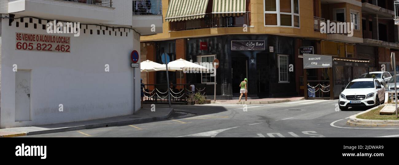 Pedestrian walking at a crossing in a city street,  Torrevieja, Spain. European travel. Stock Photo
