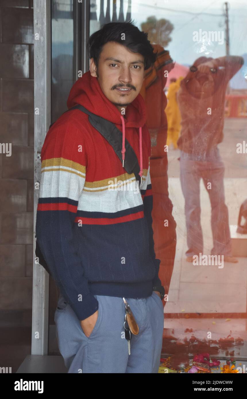 A Indian young guy looking at camera while posing for photo Stock Photo