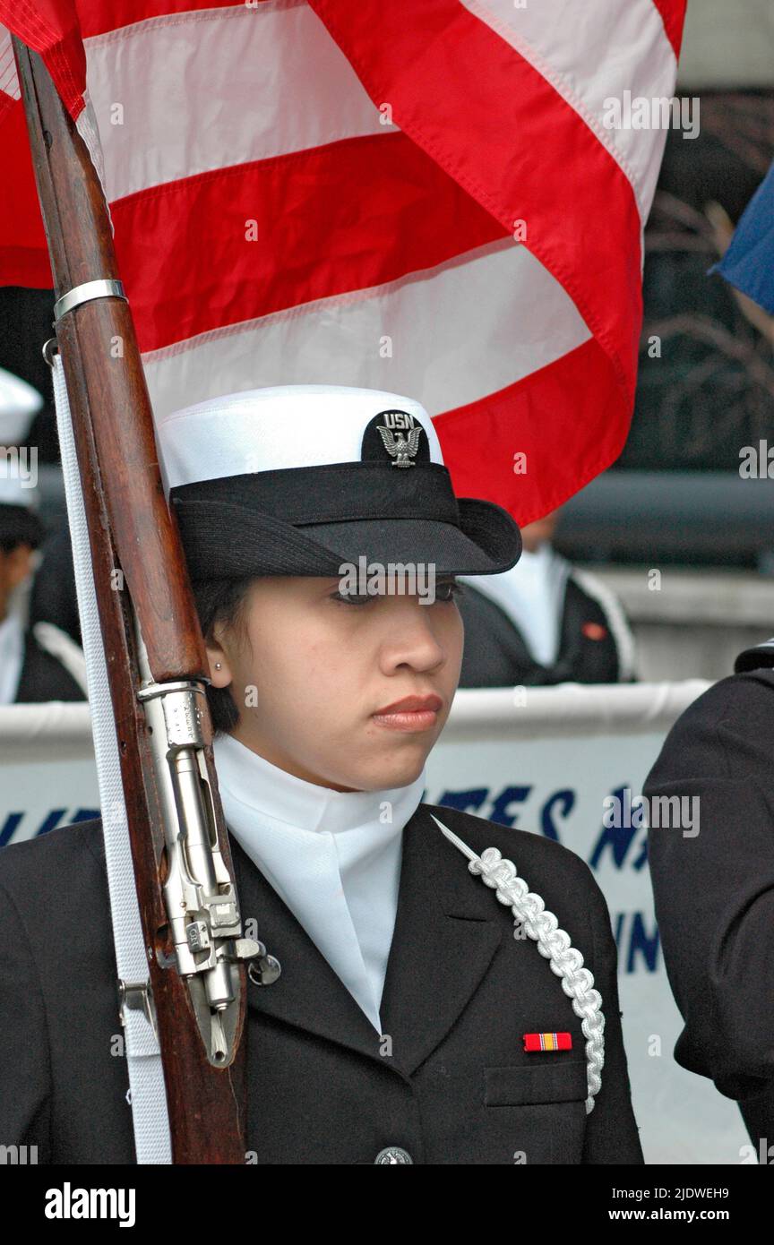 male and females' high school Students in the Navy Navel ROTC corps marching with the flags, some ethnic, face Stock Photo