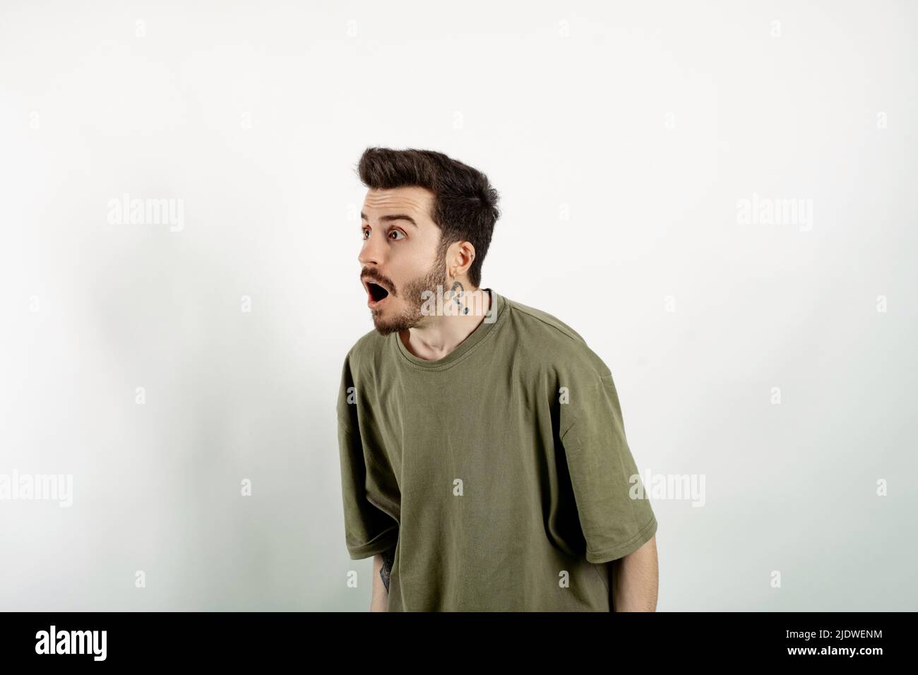 Portrait of young surprised emotional big eyes man with open mouth got  great idea and pointing with finger up on white background Stock Photo -  Alamy