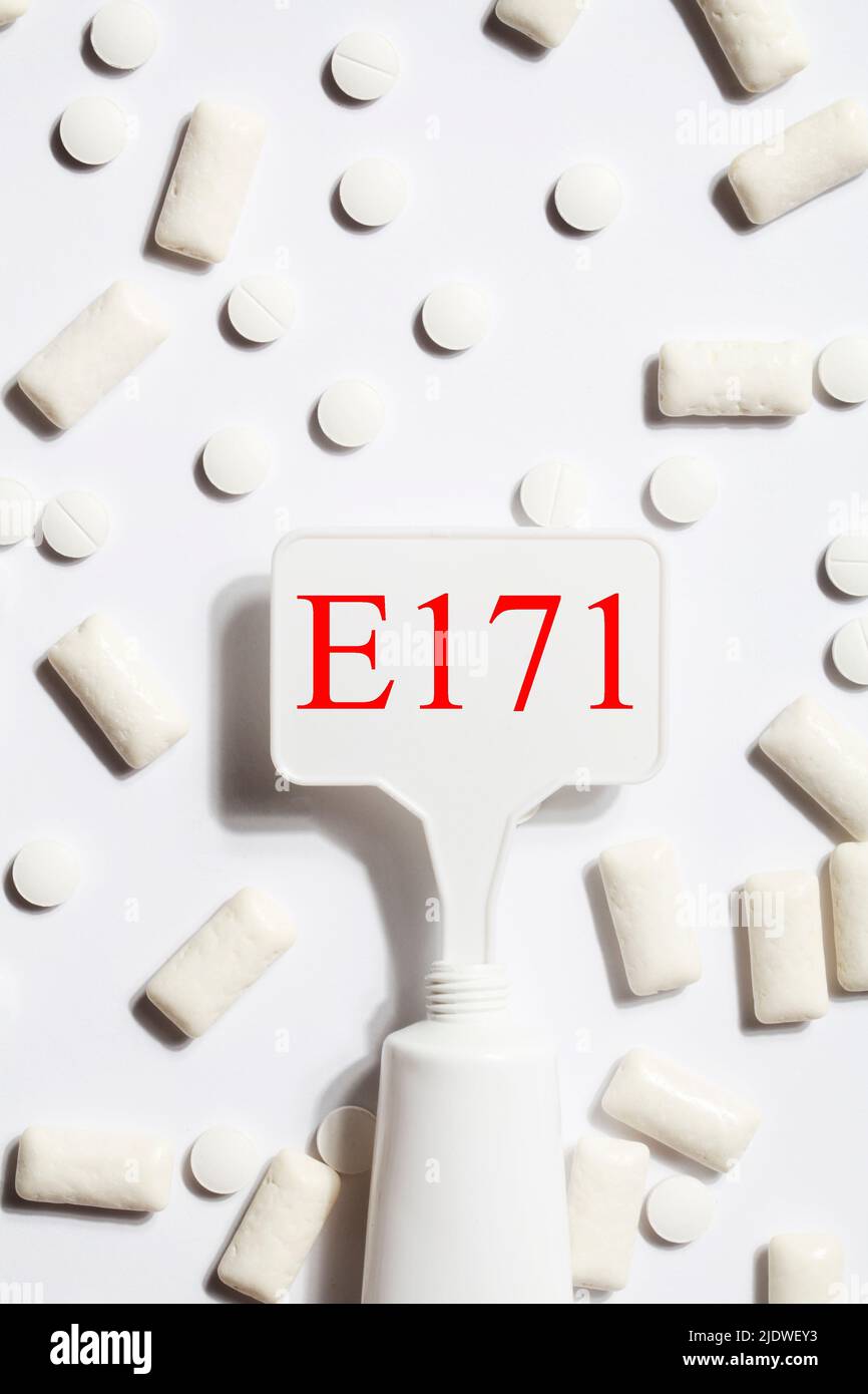 Titanium dioxide, E171, dangerous additive concept. gum, pills, toothpaste or cream and sign with E171 on white background. copy space Stock Photo