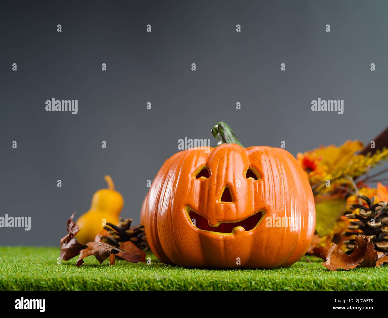 Halloween background. Orange pumpkin with a smile on green grass ...