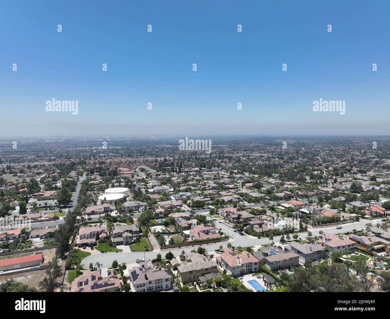 Aerial view of wealthy Alta Loma community and mountain range, Rancho