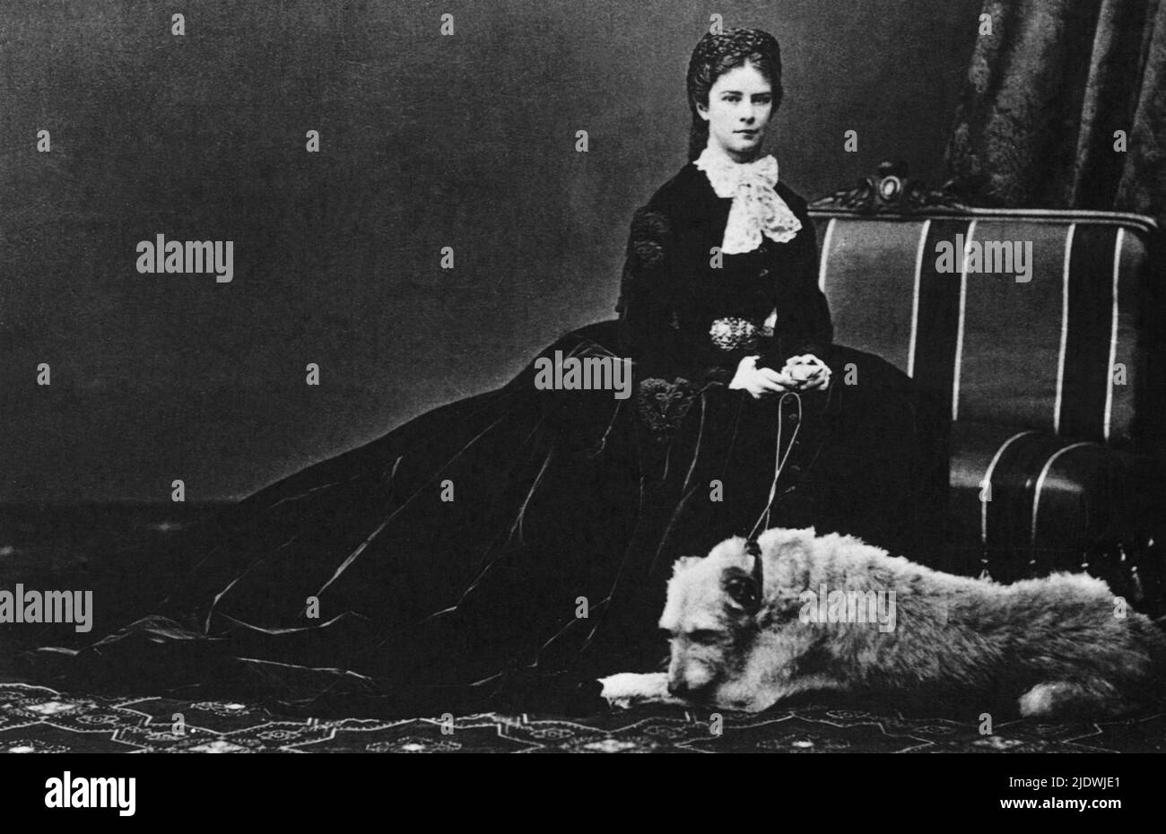 1868  , Wien , Austria   : The celebrated austrian  Empress Elisabeth of HABSBURG   ( SISSI von Wittelsbach  , 1937 - 1898 ) with his dog SHADOW .  Wife of  Kaiser Franz Josef ( 1830 - 1916 ) , Emperor of Austria , King of Hungary and Bohemia . Mother of suicided prince Rudolf ( 1850 - 1889 ). The Empress was killed by the italian anarchist Luigi Luccheni in Geneva  - FRANCESCO GIUSEPPE - JOSEPH - ABSBURG - ASBURG - ASBURGO - NOBILITY - NOBILI - NOBILTA' - REALI  - HASBURG - ROYALTY - ELISABETTA DI BAVIERA  - triste - sad - tristezza   - pizzo - lace   - RODOLFO  - anoressica - depressa - depr Stock Photo