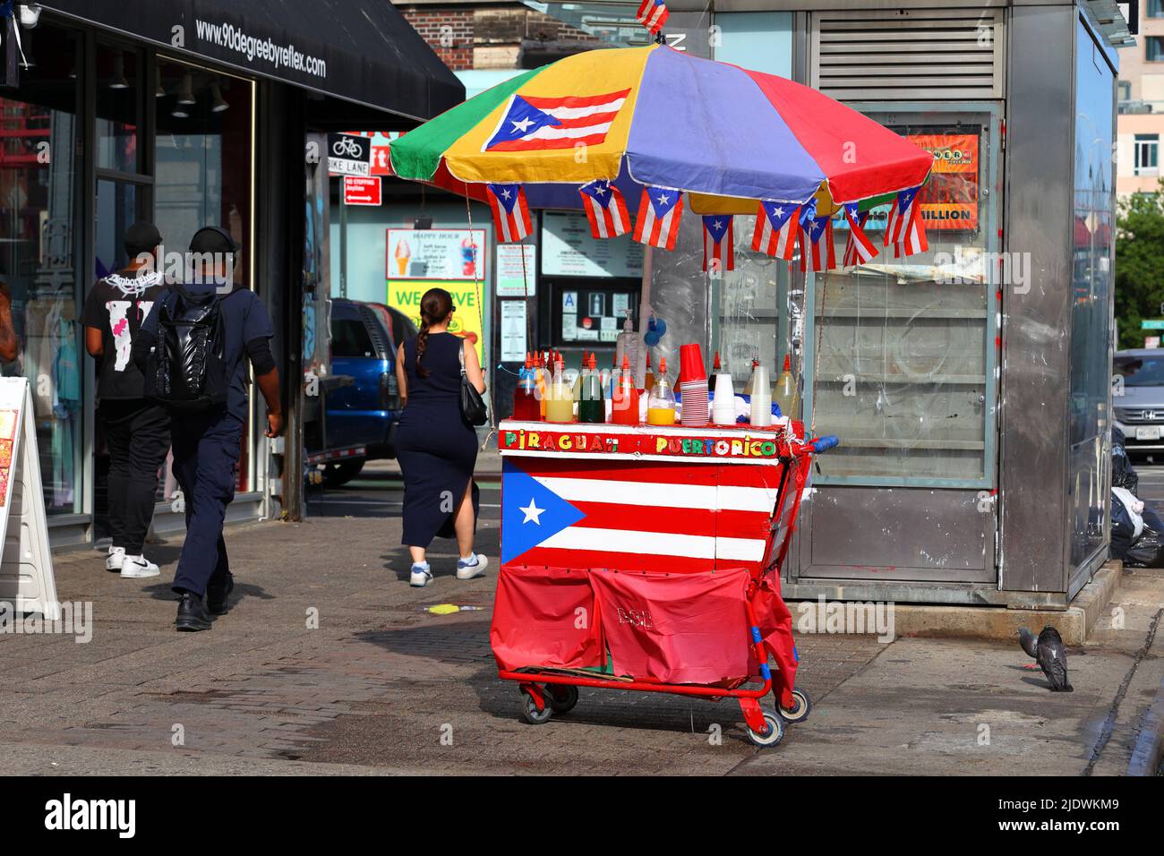 A colorful piragua shaved ice pushcart adorned with flags of Puerto Rico in Manhattan's Lower East Side in New York. Stock Photo