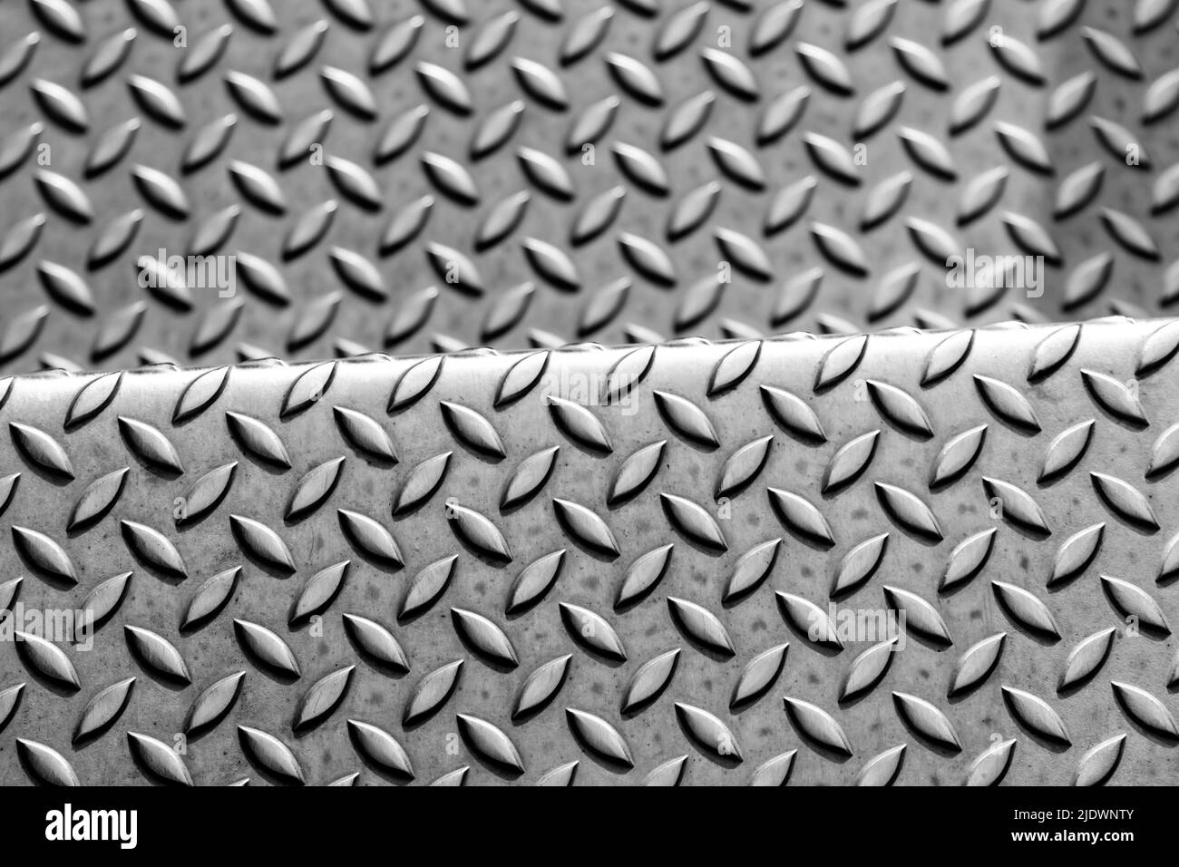 Solid diamond metal plate surface shows stainless steel flooring in industrial manufactury as