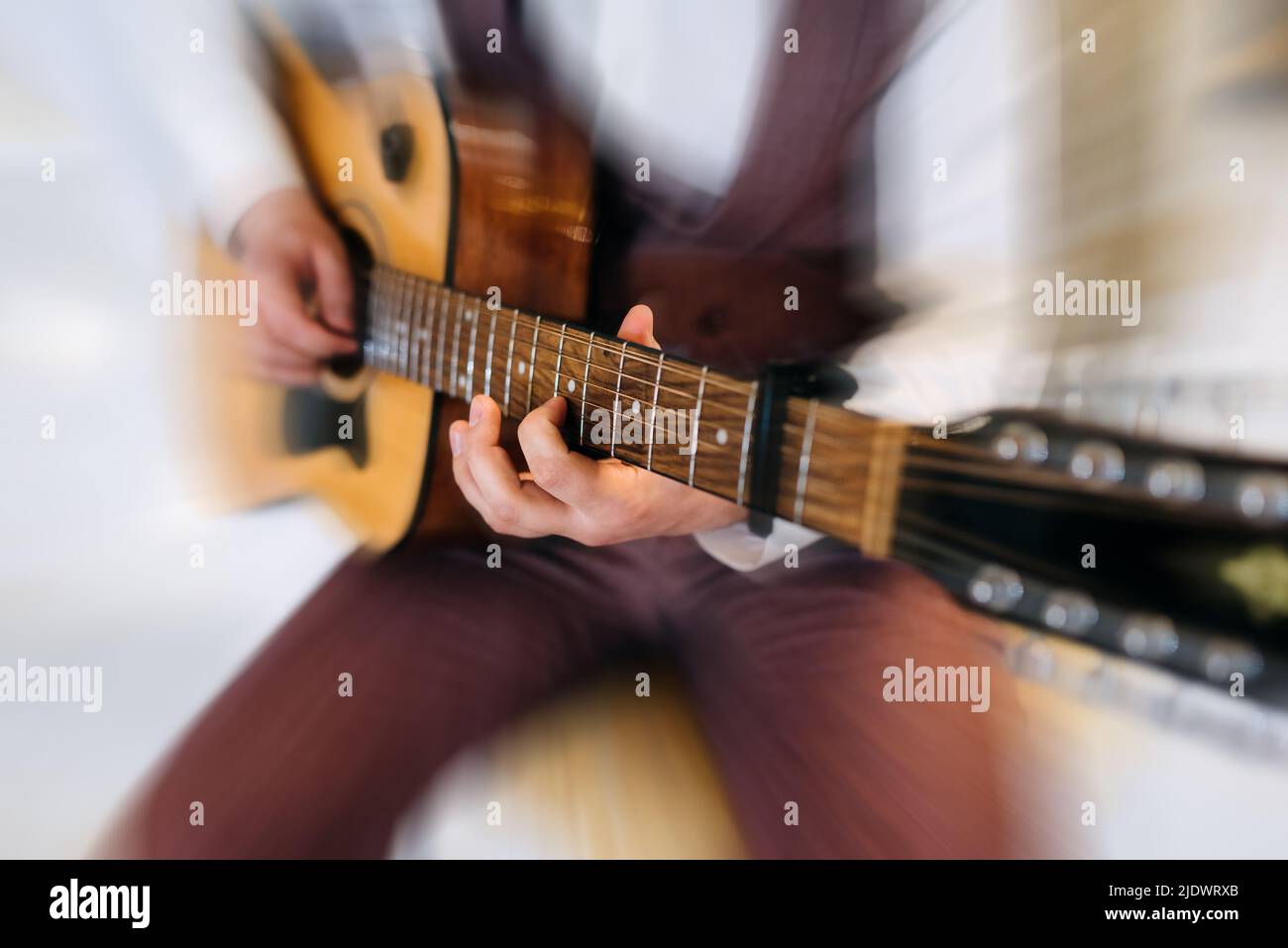 Rock band studio rehearsal. Male musician playing bass guitar before