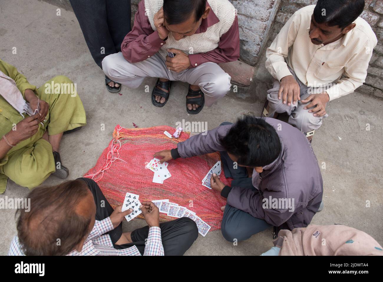 Mature indian men playin cards game outdoors Stock Photo