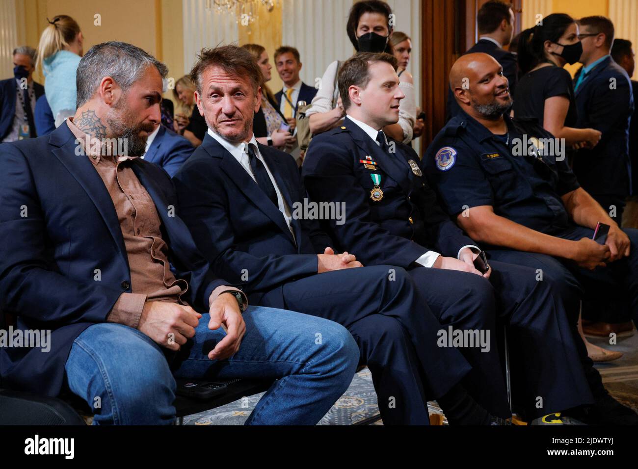 Actor Sean Penn sits with former Washington police officer Michael Fanone, Metropolitan police officer Daniel Hodges and Metropolitan police officer Harry Dunn, all of whom were assaulted during the January 6, 2021 attack on the U.S. Capitol, during the fifth public hearing of the U.S. House Select Committee to Investigate the event, on Capitol Hill in Washington, U.S., June 23, 2022. REUTERS/Jim Bourg Stock Photo