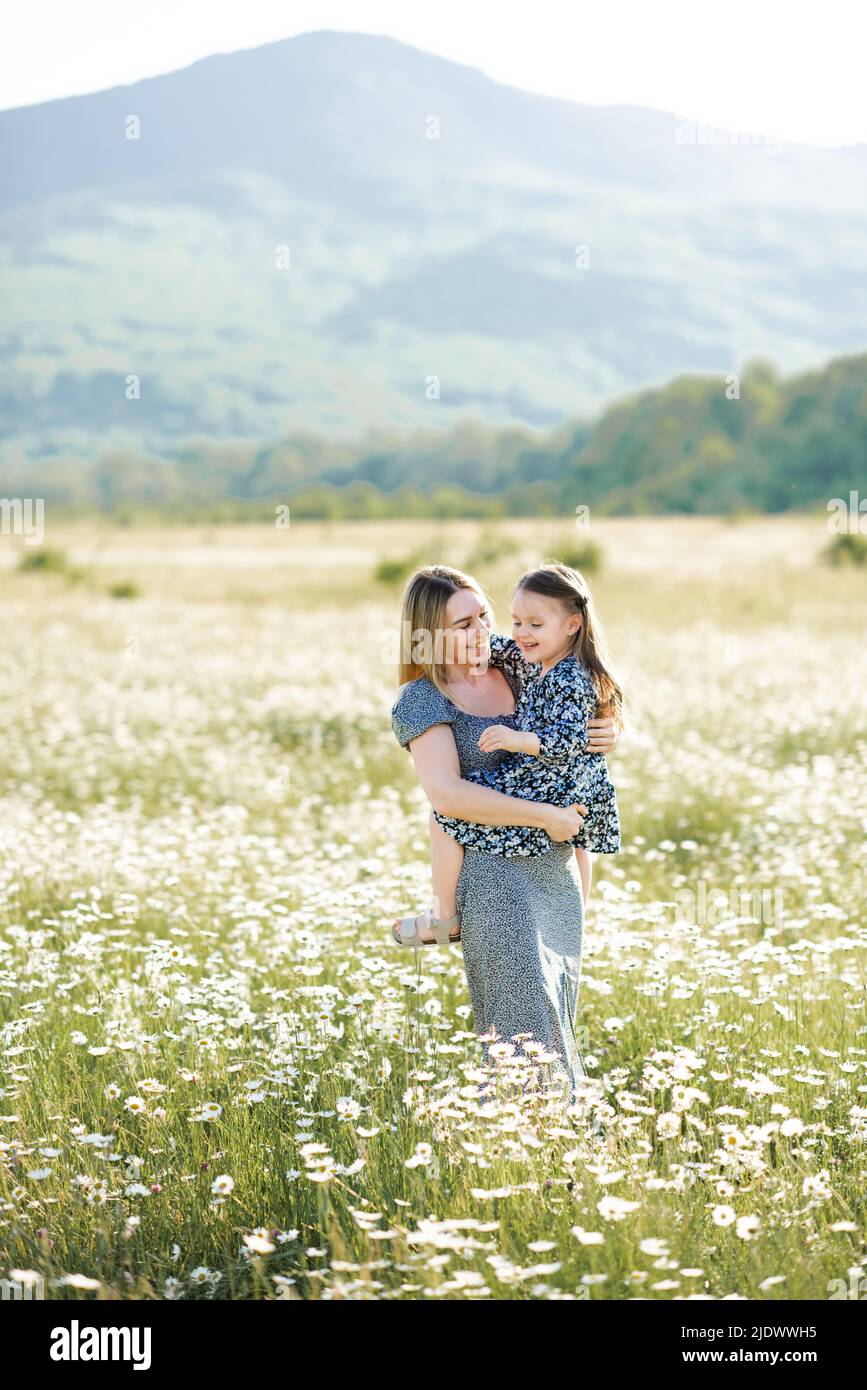 Cute smiling woman holding baby girl daughter 34 year old wear similar