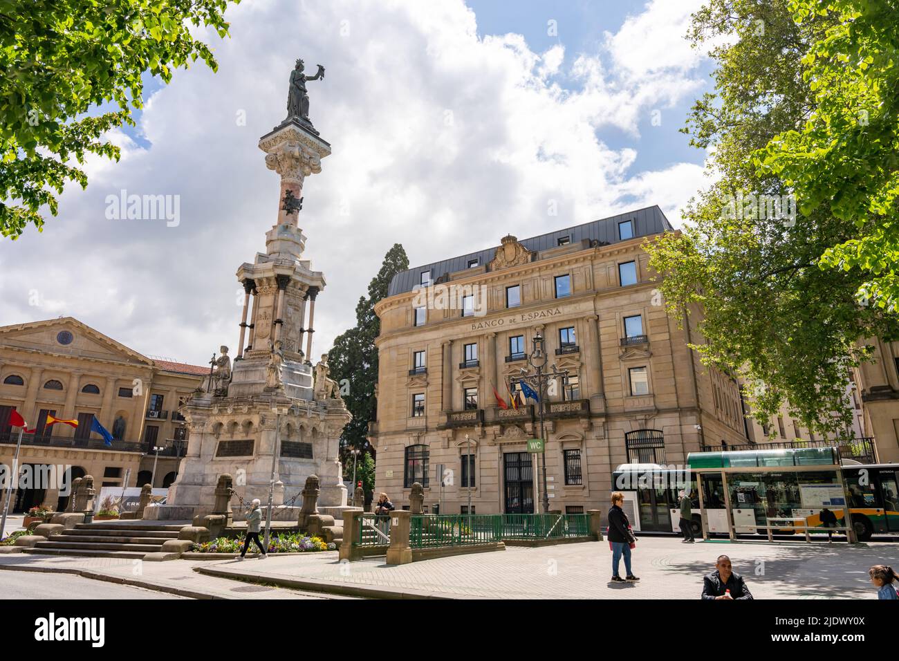 Pamplona, Spain - May 6th 2022 - Tourists passing the Monumento a los Fueros (monument of the charters) Stock Photo
