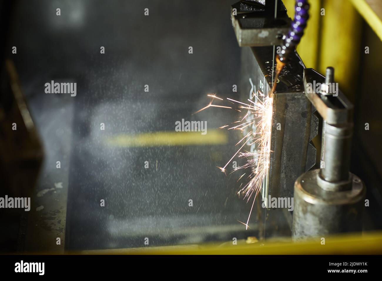 Closeup of electrical discharge machining process used for shaping