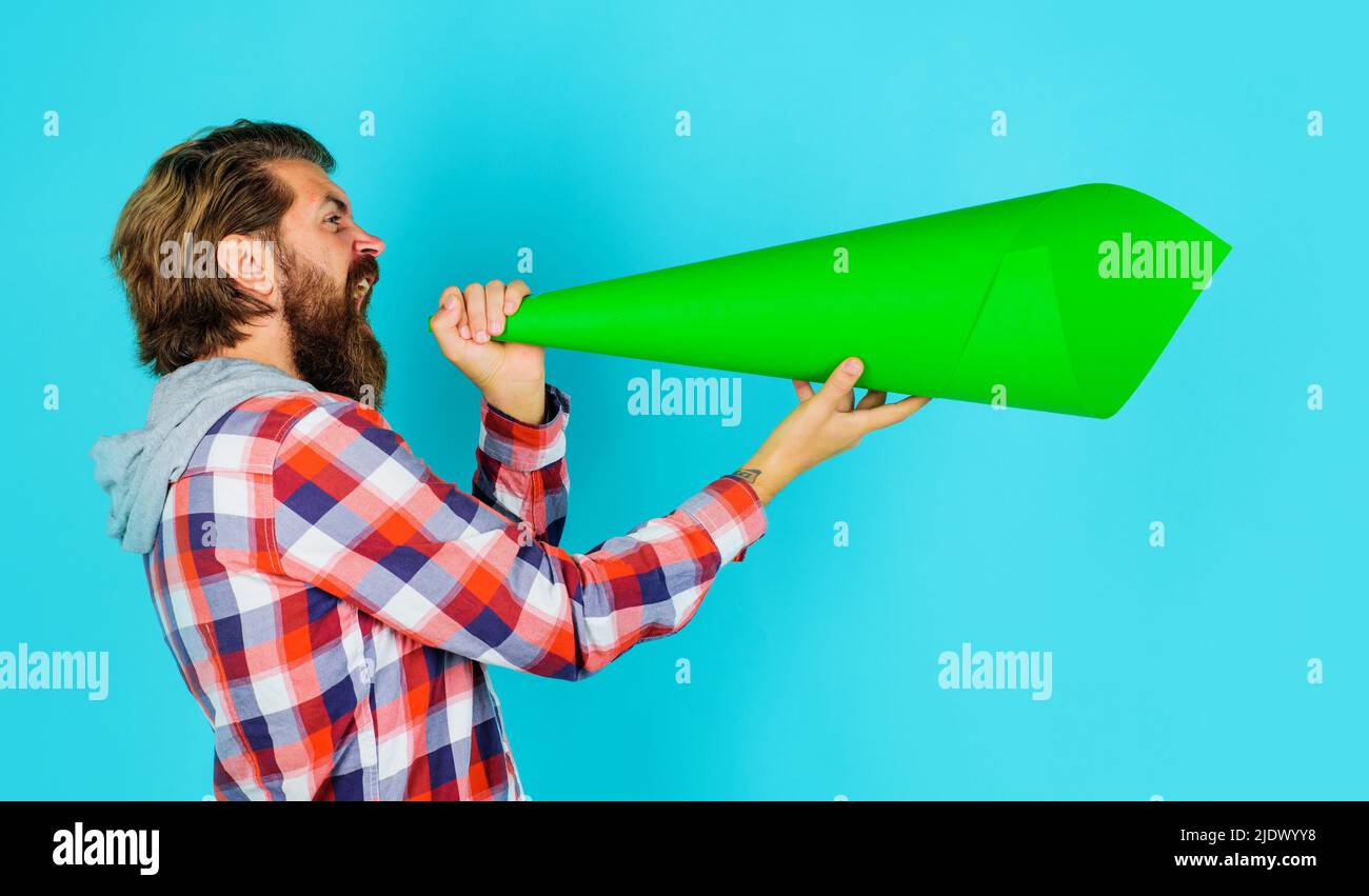 Protest. Bearded man shouting in paper loudspeaker. Own opinion. Freedom of speech. Worlds problems. Stock Photo