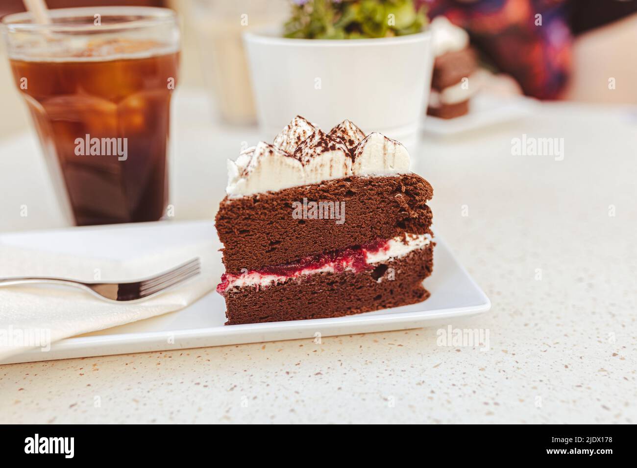 Japanese chocolate cheesecake with raspberry jam and whipped cream on ...