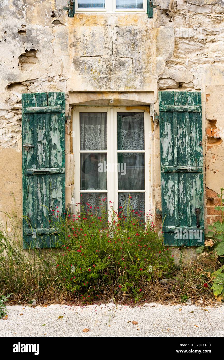 Old French window with worn out green wooden shutters Stock Photo