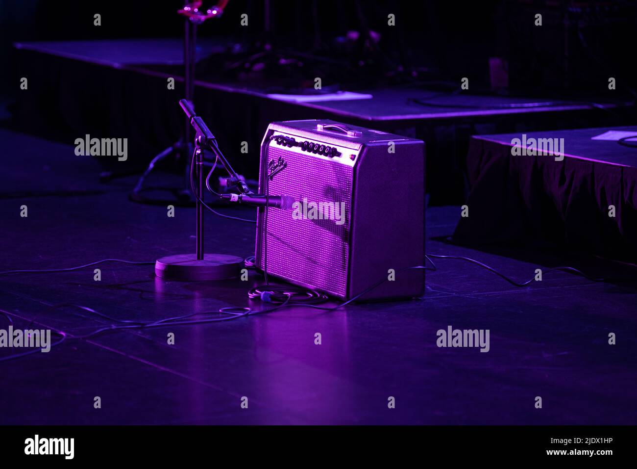 Fender Amplifier and guitar set up on stage under pruple stage lighting