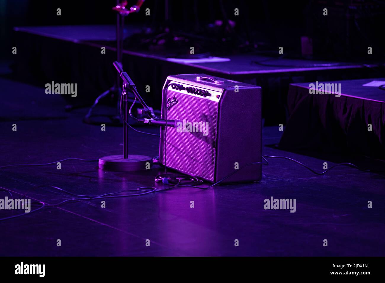 Fender Amplifier and guitar set up on stage under pruple stage lighting