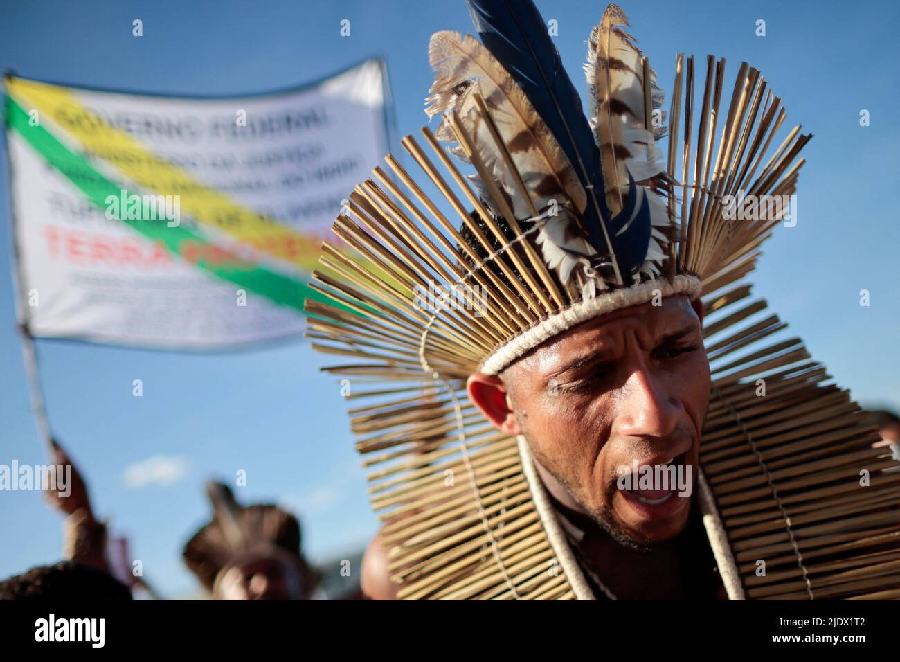 An indigenous man takes part in a protest against Brazilian President Jair Bolsonaro's government, Brazil's National Indian Foundation (FUNAI)'s President Marcelo Augusto Xavier da Silva, to ask the Supreme Court to define the demarcation of Indigenous lands and to demand justice for journalist Dom Phillips and indigenous expert Bruno Pereira, who were murdered in the Amazon, in Brasilia, Brazil, June 23, 2022. REUTERS/Ueslei Marcelino Stock Photo