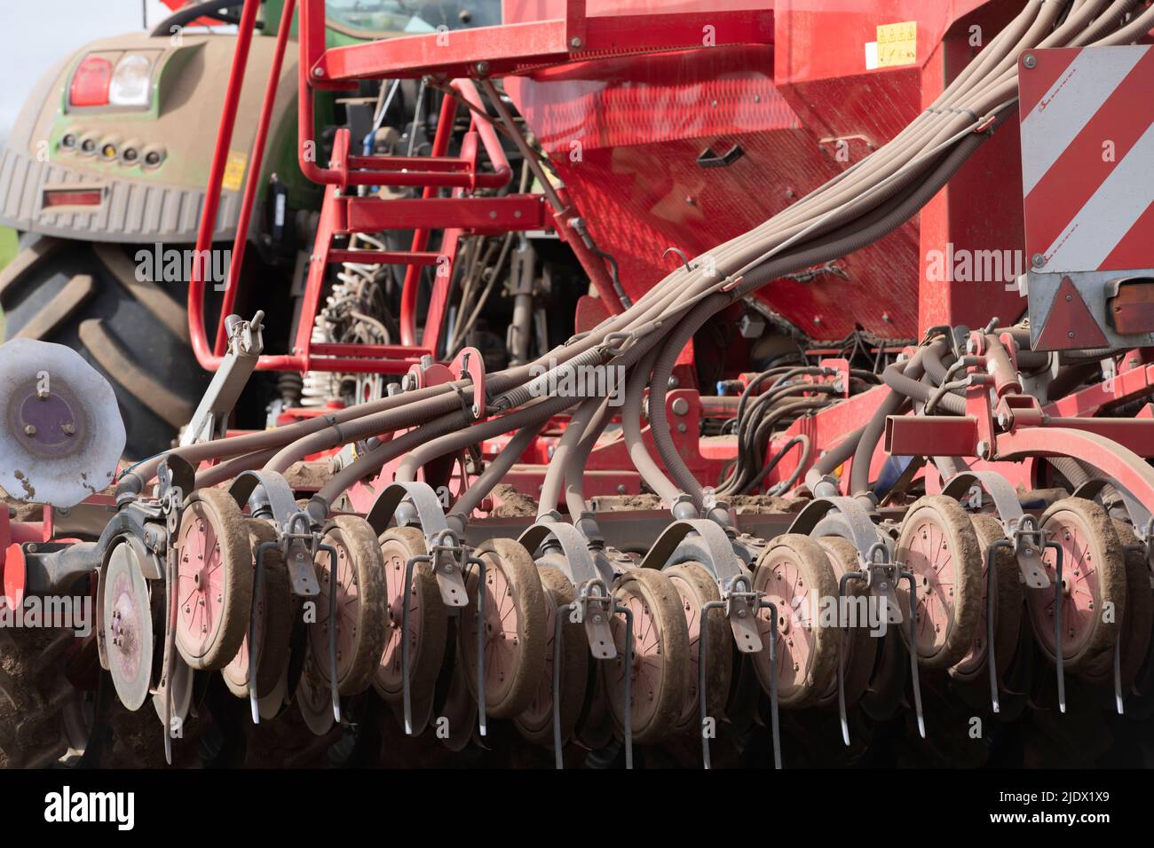 Detail of a Horsch Universal Seed Drill, Showing Hoses, Coulters, Press Wheels and Tines Stock Photo