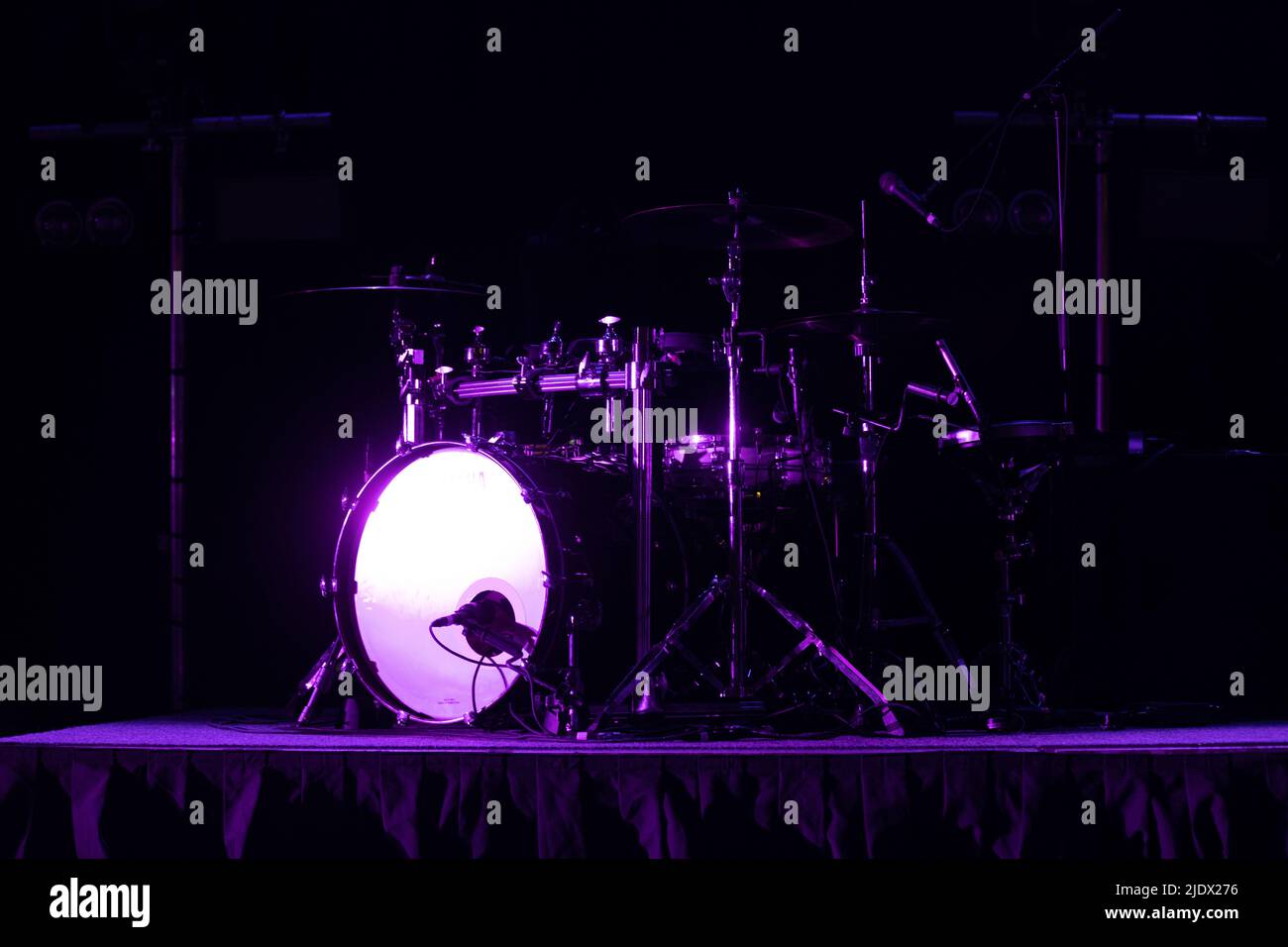 Drum kit set up on stage under stage lighting purple inc olour Stock ...