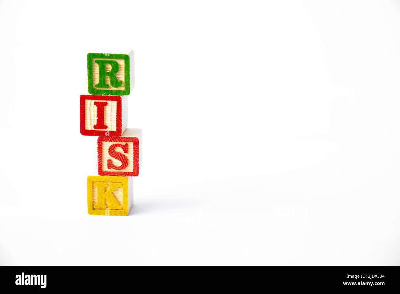 The word Risk spelled with a stack of colorful toy blocks Stock Photo