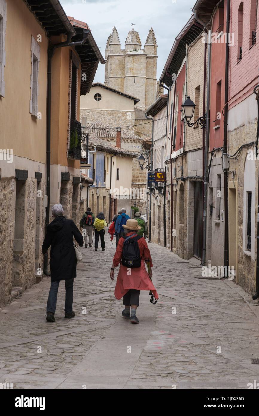 Spain, Castilla y Leon, Walking through the Streets of Castrojeriz on the Camino de Santiago, Church of San Juan in background. Stock Photo
