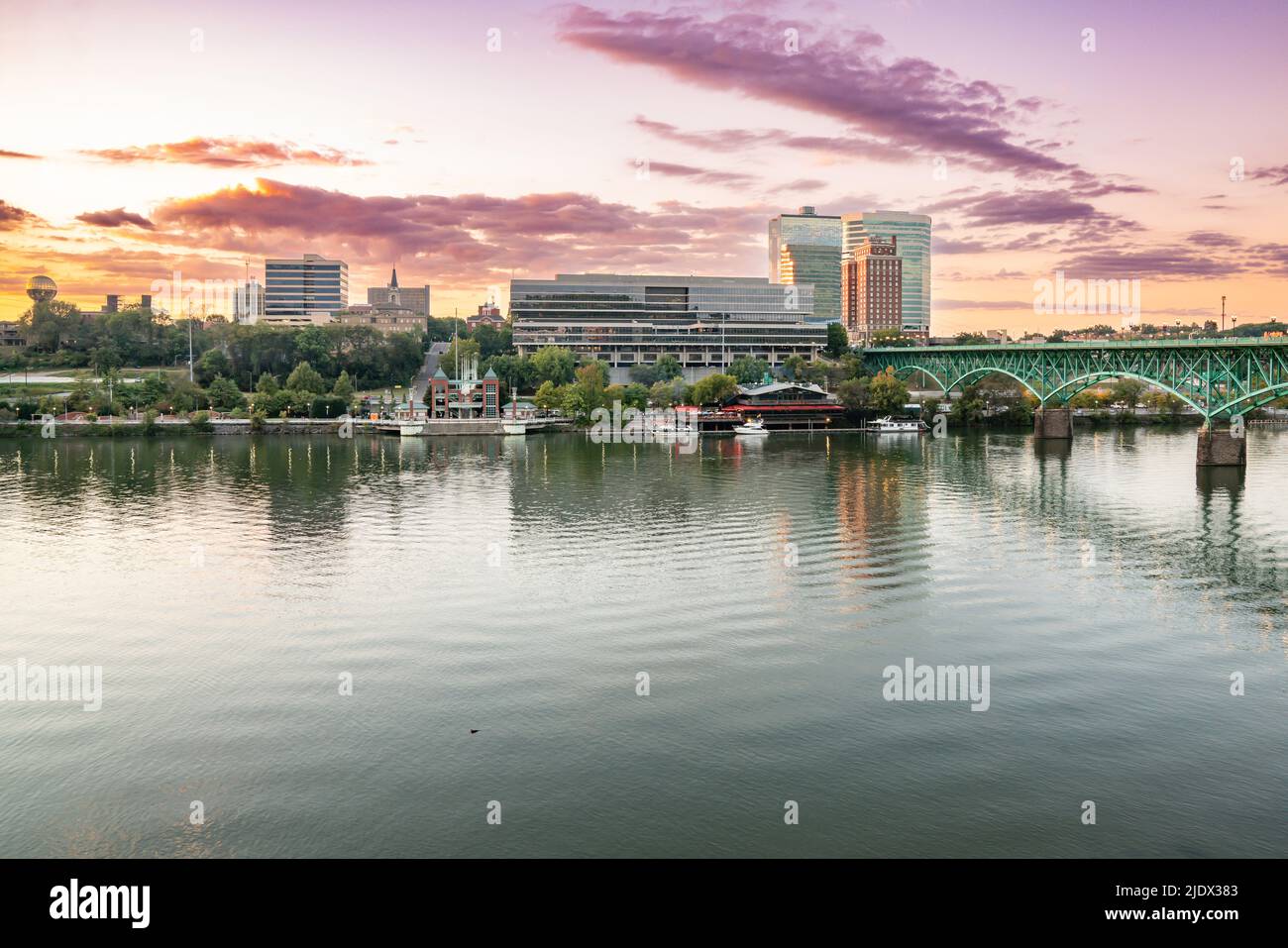 The city skyline of Knoxville along the Tennessee River at sunset Stock Photo