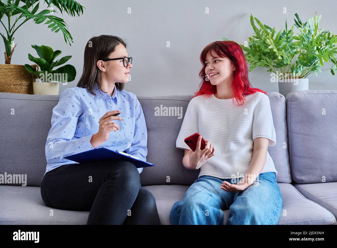 Psychologist counseling teenage female, individual therapy in doctors