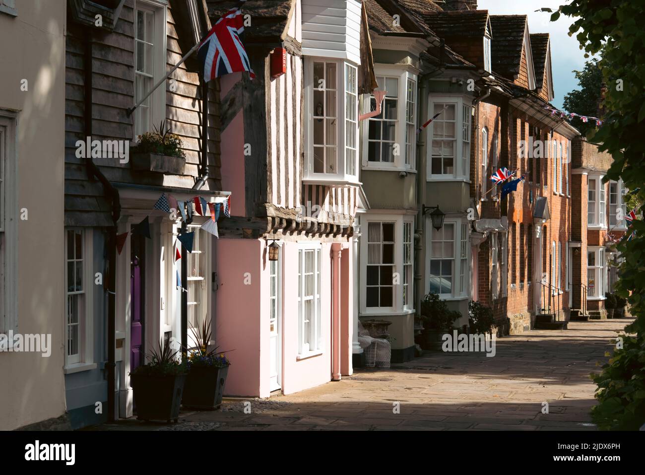 The historic Causeway with houses adorned with bunting and Union flags to celebrate the Queens Jubilee in June 2022, Horsham, West Sussx, UK Stock Photo