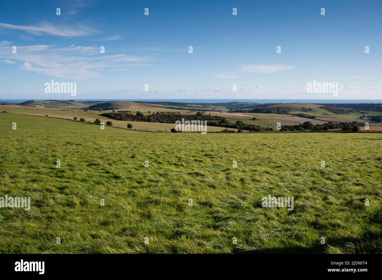 A view south from Kithurst Hill across the South Downs towards Worthing and the Rampion offshore wind farm, West Sussex, England, UK Stock Photo