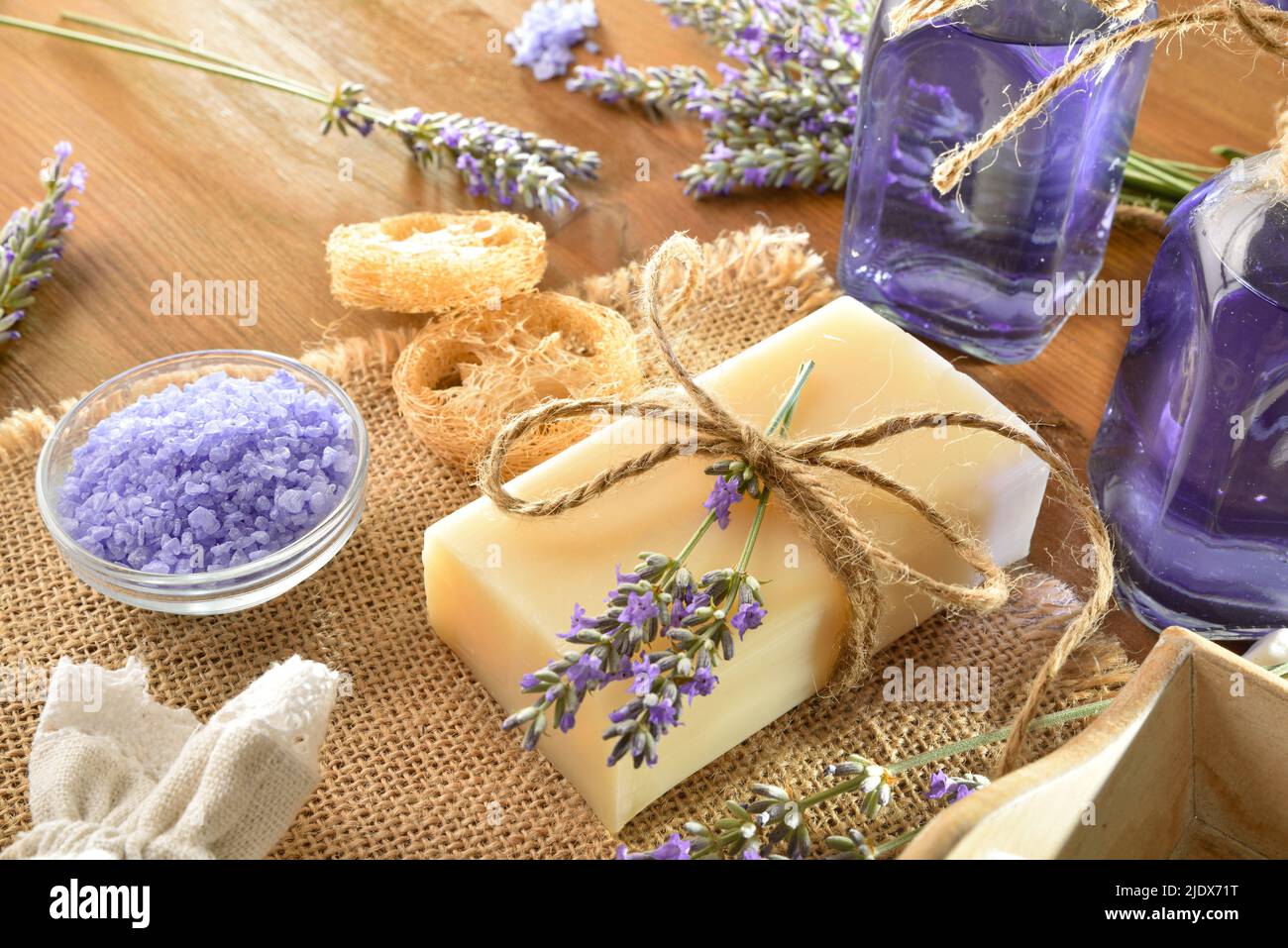 Set of natural lavender body care products on wooden table. Elevated view. Horizontal composition. Stock Photo