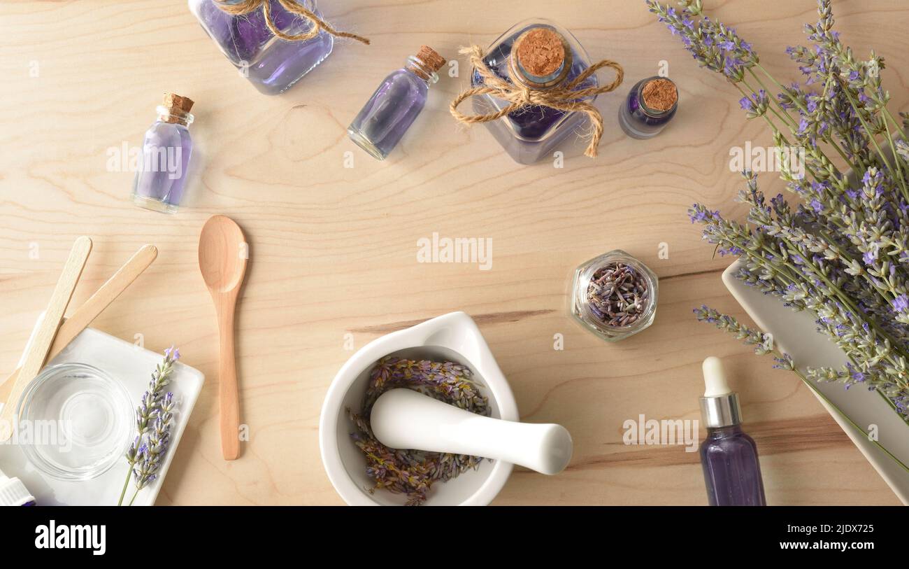 Homemade preparation of natural lavender essence with elements for the preparation and containers with lavender liquid. Top view. Horizontal compositi Stock Photo