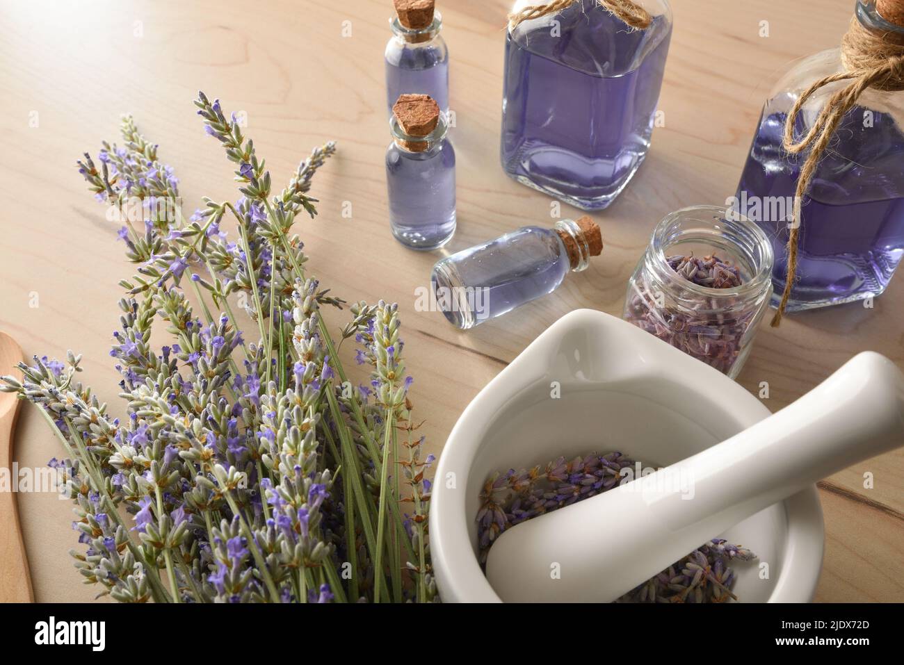 Homemade preparation of natural lavender essence with elements for the preparation and containers with lavender liquid close up. Elevated view. Horizo Stock Photo