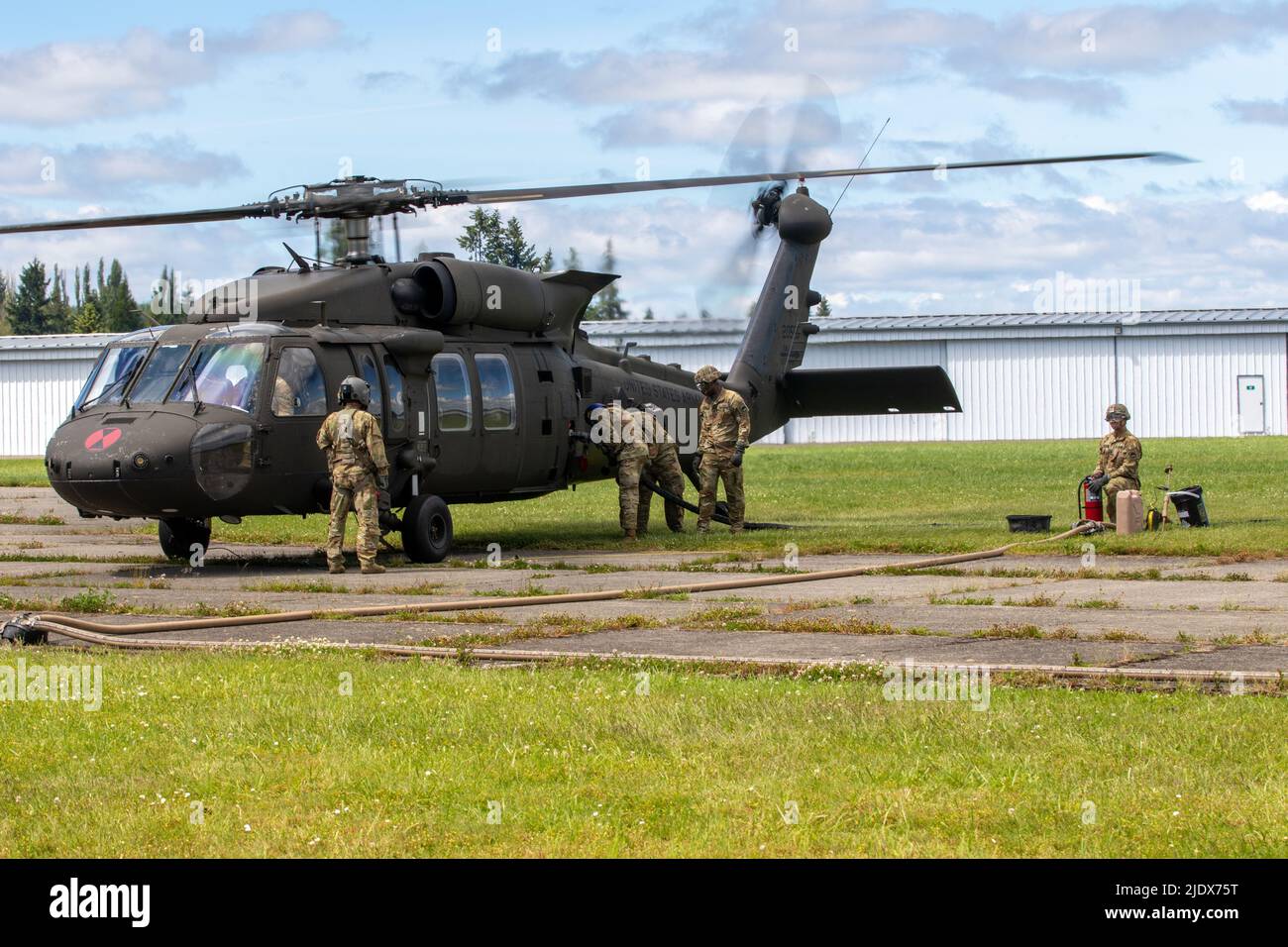 Soldiers assigned to Alpha Company, 46th Aviation Support Battalion, 16th Combat Aviation Brigade, operate a forward arming and refueling point at the Chehalis-Centralia Airport, Wash. on Jun. 22, 2022. The Soldiers were training U.S. Army Reserve and U.S. Air Force servicemembers on helicopter refueling procedures. (U.S. Army photo by Capt. Kyle Abraham, 16th Combat Aviation Brigade) Stock Photo