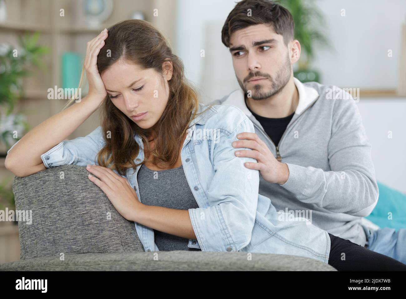 upset couple sitting after arguing on couch Stock Photo - Alamy