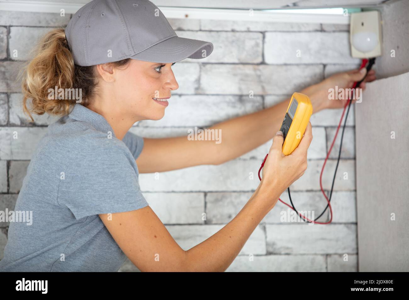 female electrician checking a plug Stock Photo - Alamy