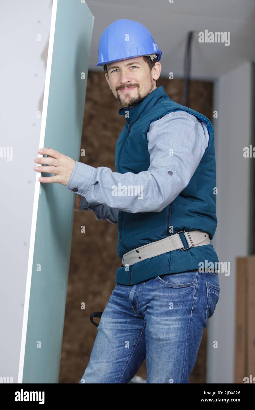 mover carrying piece of furniture to the house Stock Photo Alamy