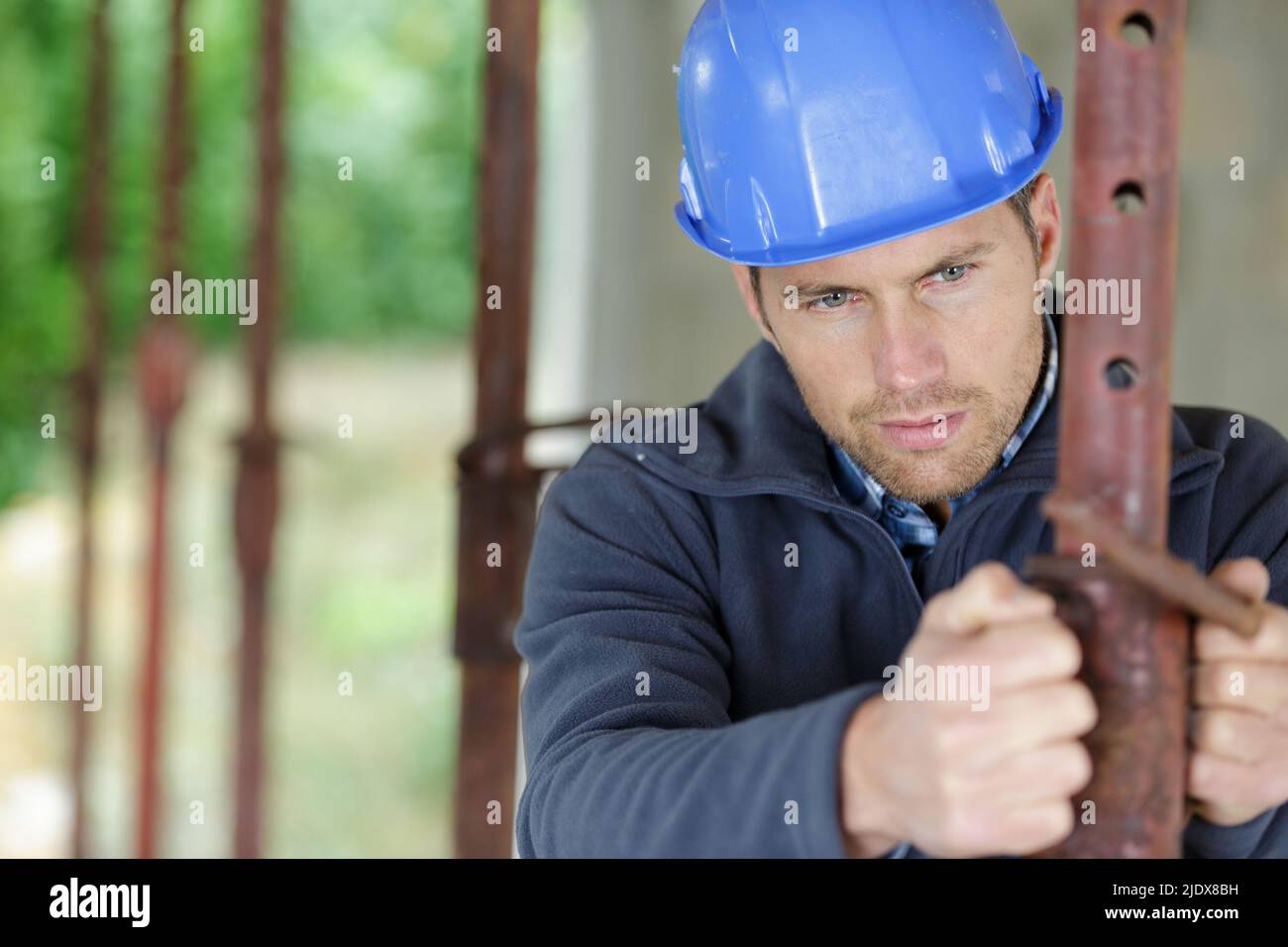 construction worker with helmet and a pipe in hands Stock Photo - Alamy