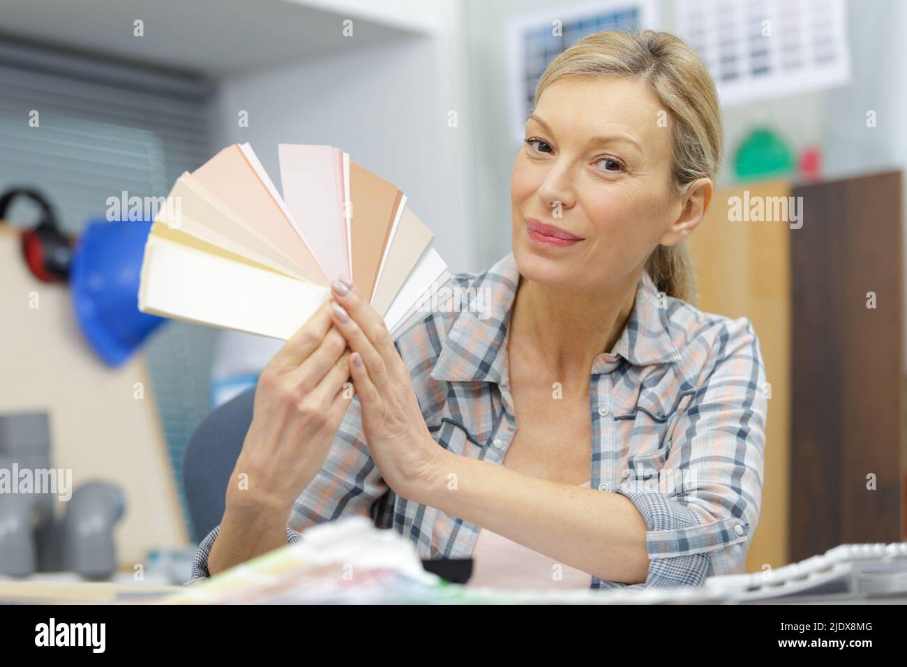 blonde focused designer working at her desk in creative office Stock Photo