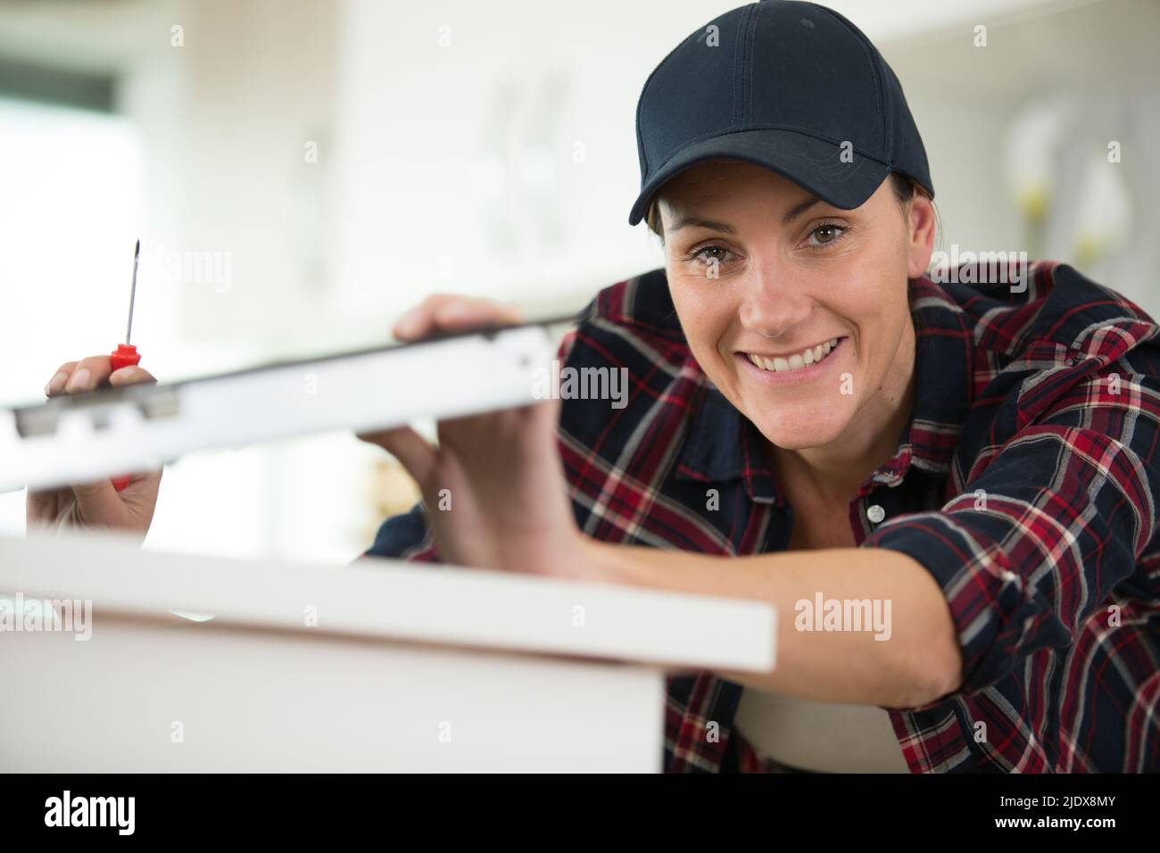 Kitchen Counter Assistant female worker installing top counter kitchen Stock Photo - Alamy