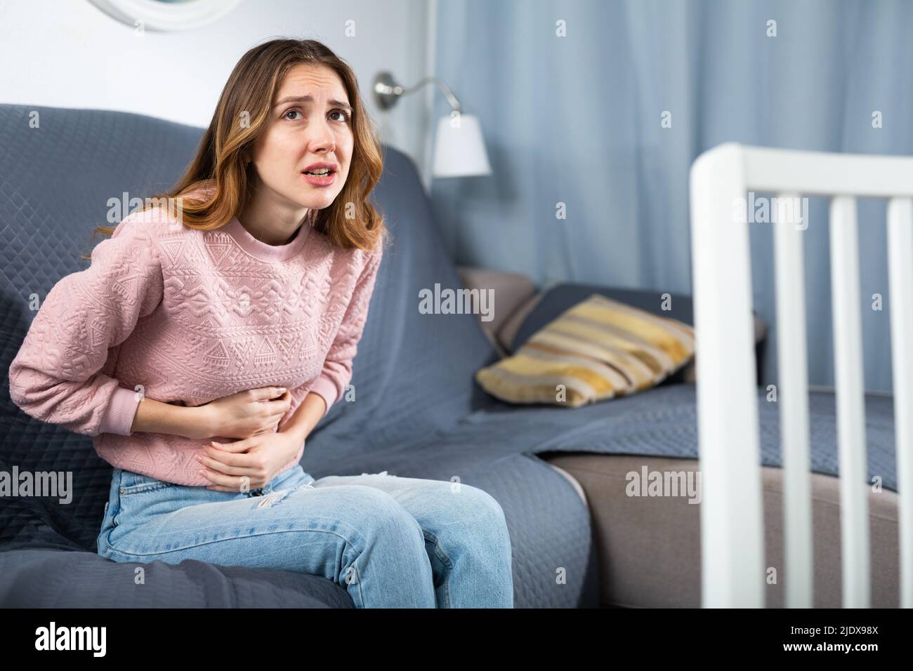 Young woman suffering from abdominal pain Stock Photo