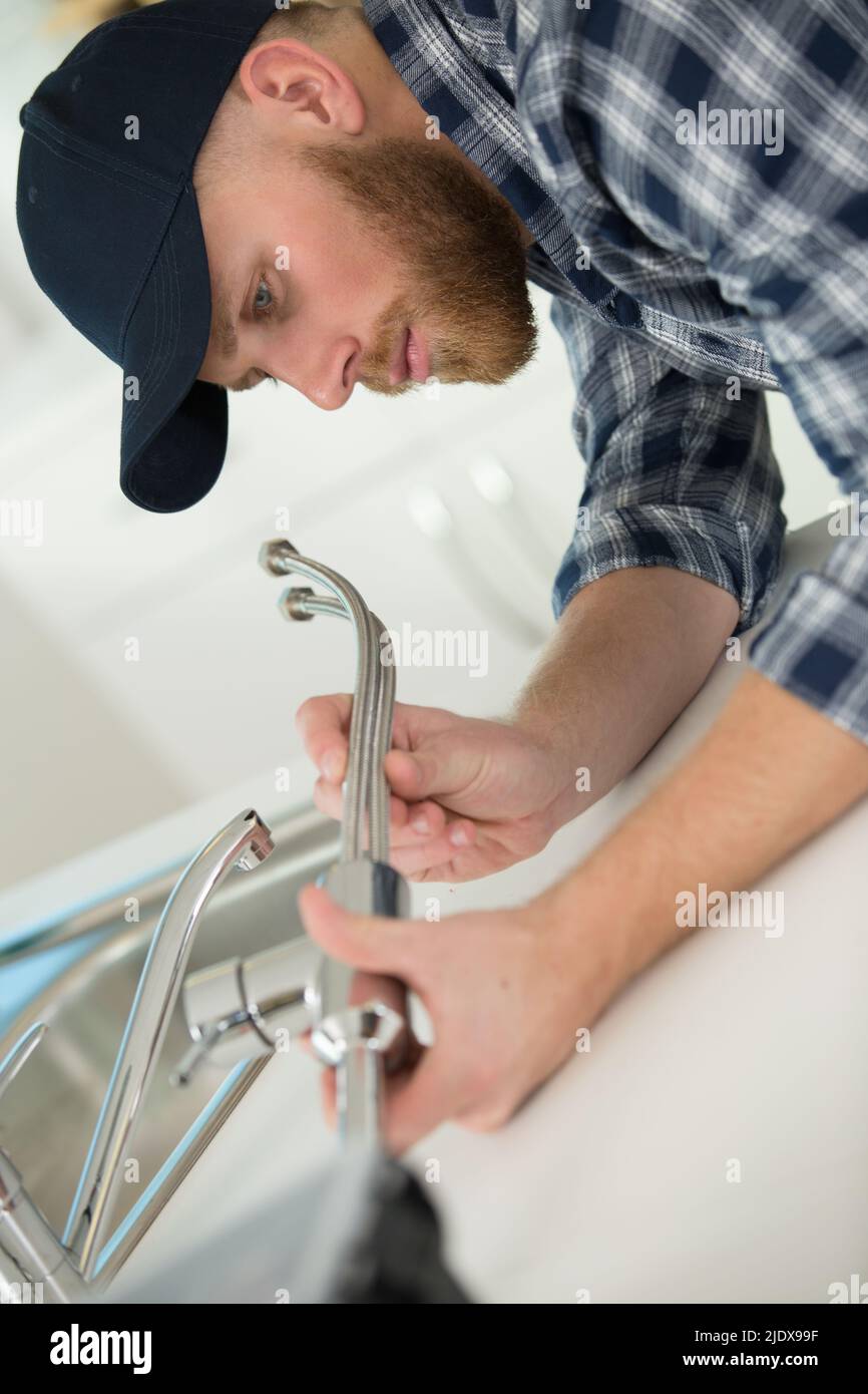 plumber fitting metal sink hoses Stock Photo Alamy