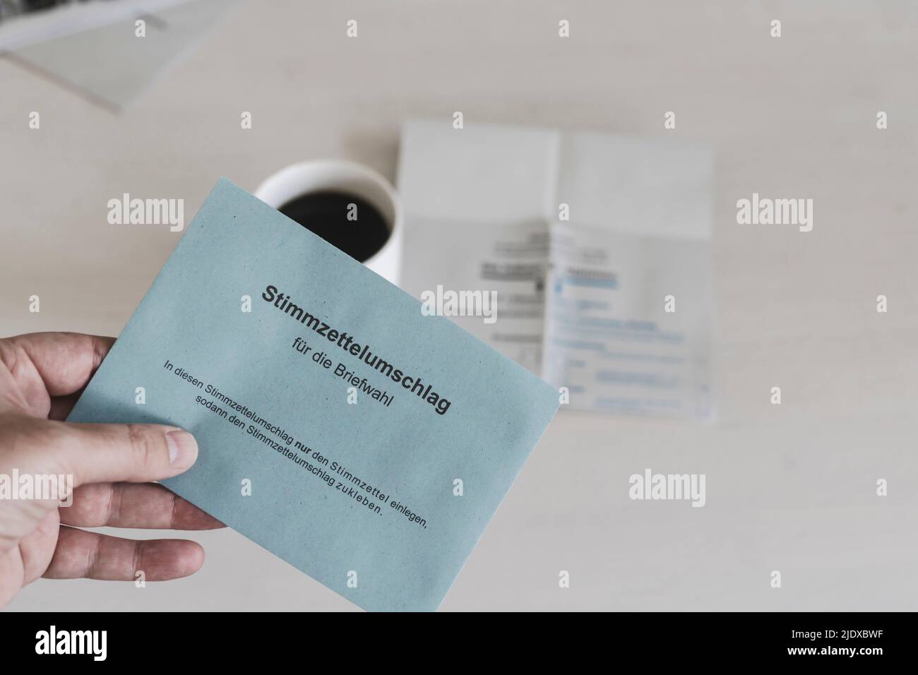 Man holding German ballot paper over coffee cup Stock Photo - Alamy